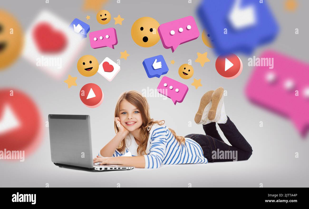 smiling girl with laptop and internet icons Stock Photo - Alamy