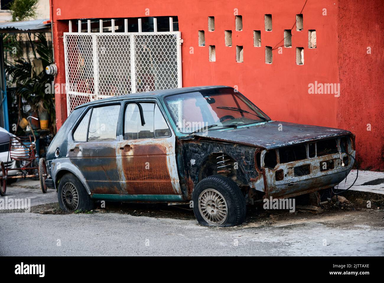 An old Destroyed car on the street in Valladolid, Yucatan, Mexico
