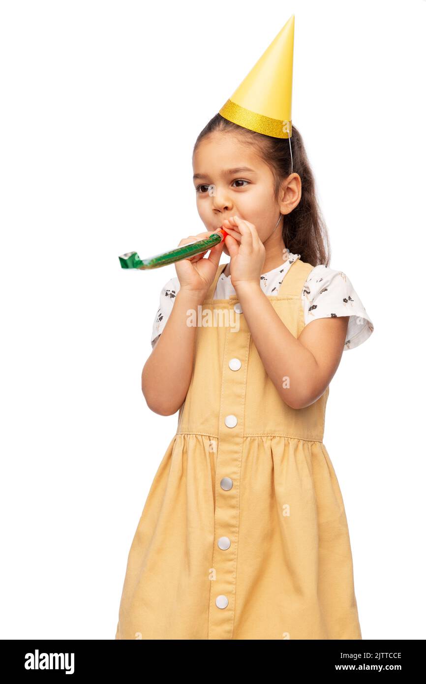 smiling girl in birthday party hat with blower Stock Photo - Alamy