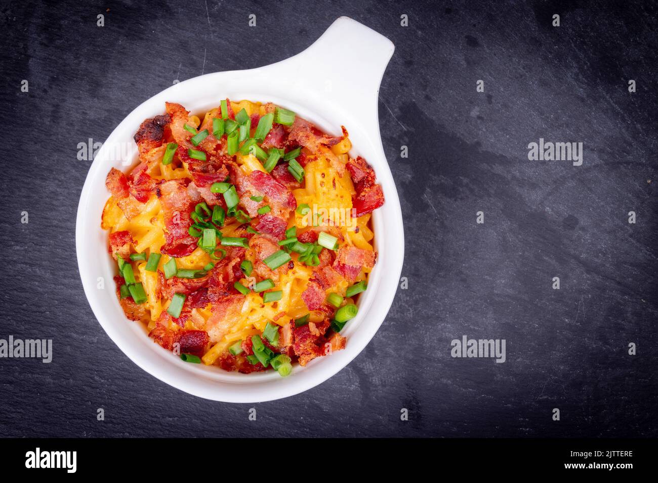 Delicious Mac and cheese with bacon and green onion closeup Stock Photo