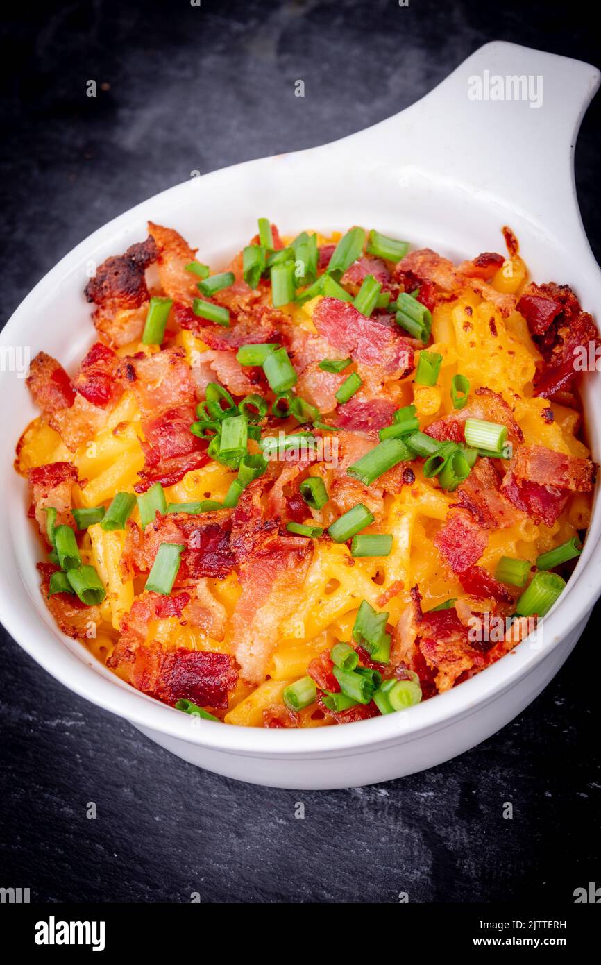 Delicious Mac and cheese with bacon and green onion closeup Stock Photo