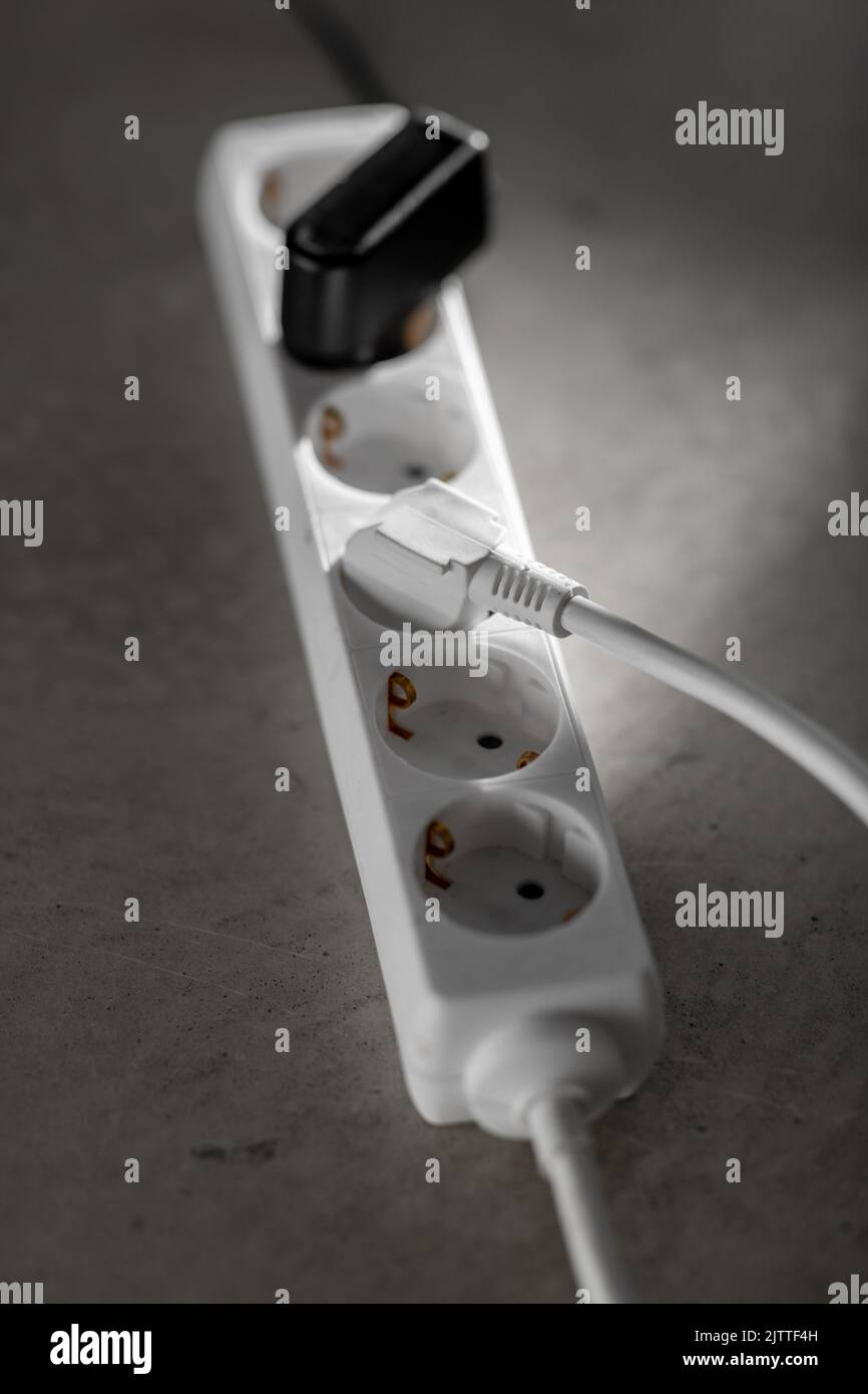 close up of socket with plugs and charger on floor Stock Photo Alamy