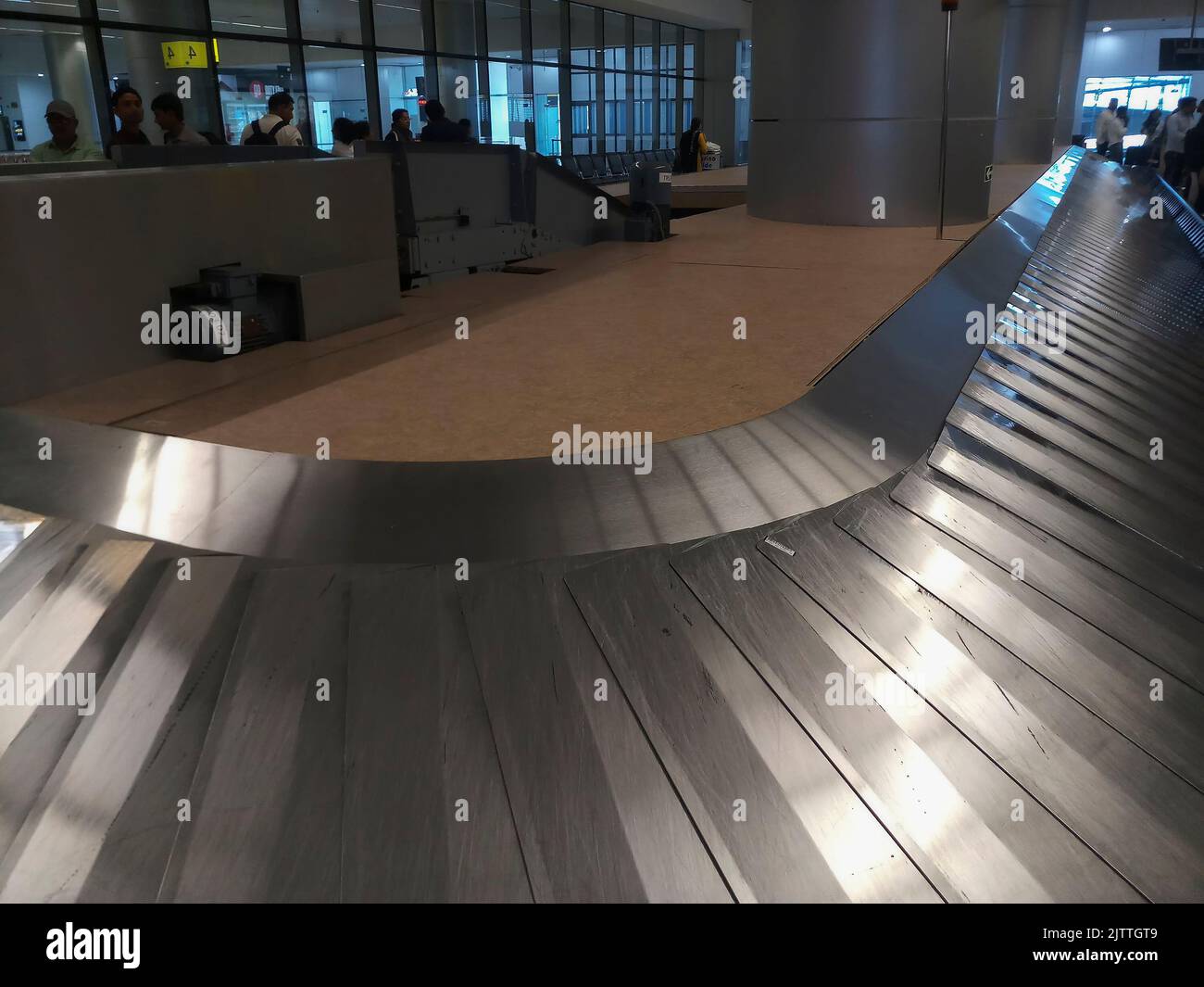 Delhi , India - 14th May 2019 : Close up view of automated airport luggage belt in motion, passengers are waiting for their luggages. Stock Photo