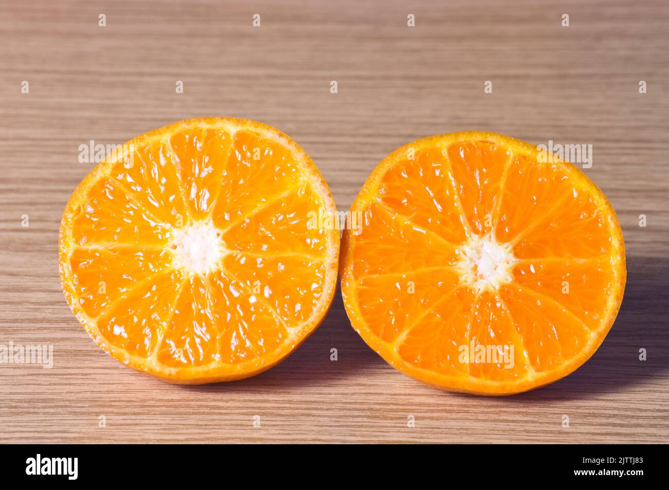 Very sweet tangerine cut in half and ready to taste Stock Photo Alamy