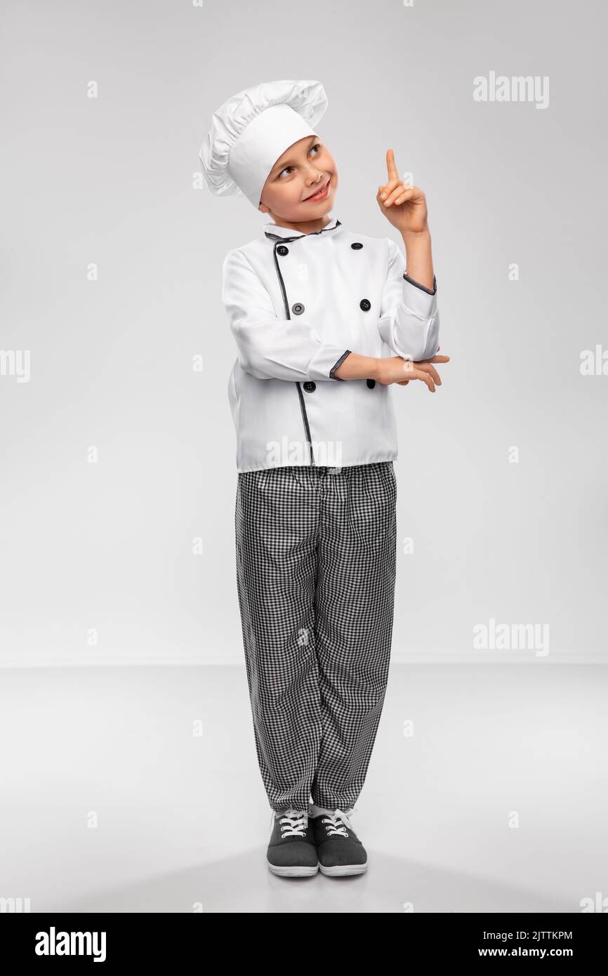 little boy in chef's toque pointing finger up Stock Photo - Alamy