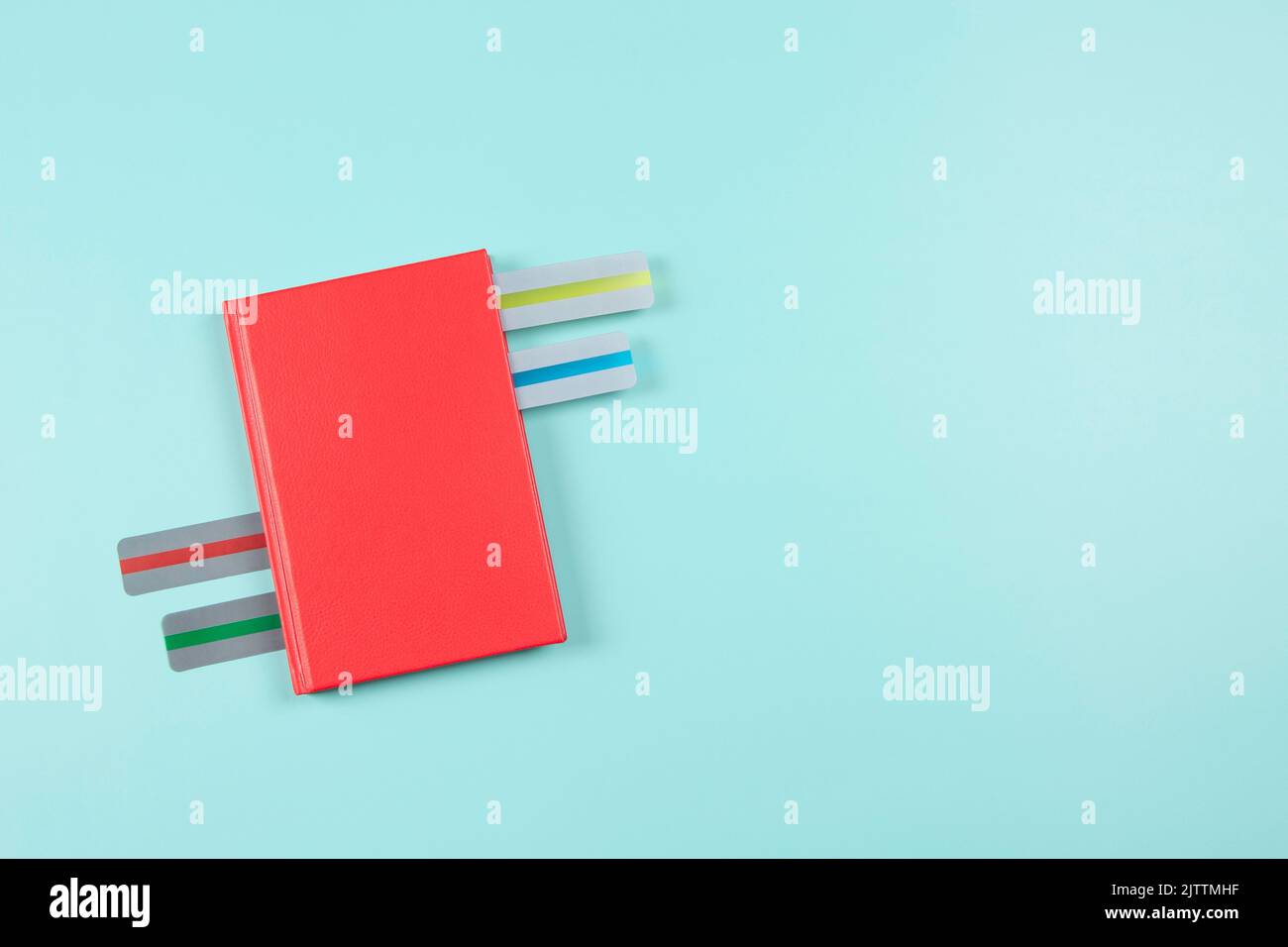 Dyslexia. Top view to red book with different colors reading highlight