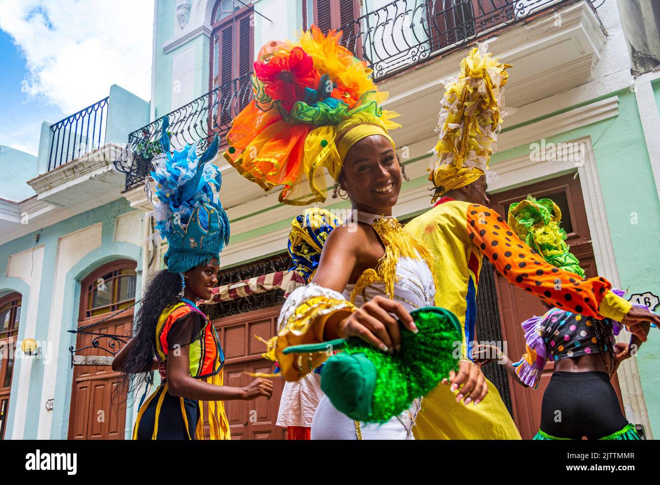 A group of Cuban entertainers and musicians stilt walk their way around downtown, Havana, Cuba, performing for both locals and tourists. Stock Photo