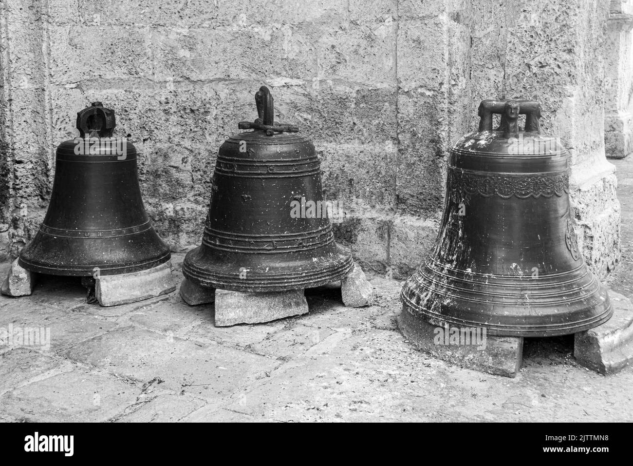 Three bells in black and white outside of a church, Havana, Cuba. Stock Photo