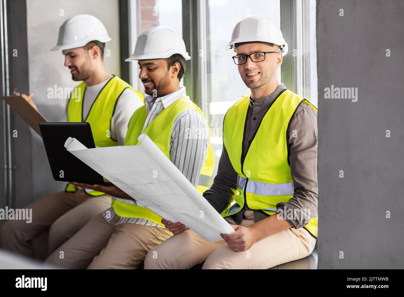 male architects in helmets working at office Stock Photo