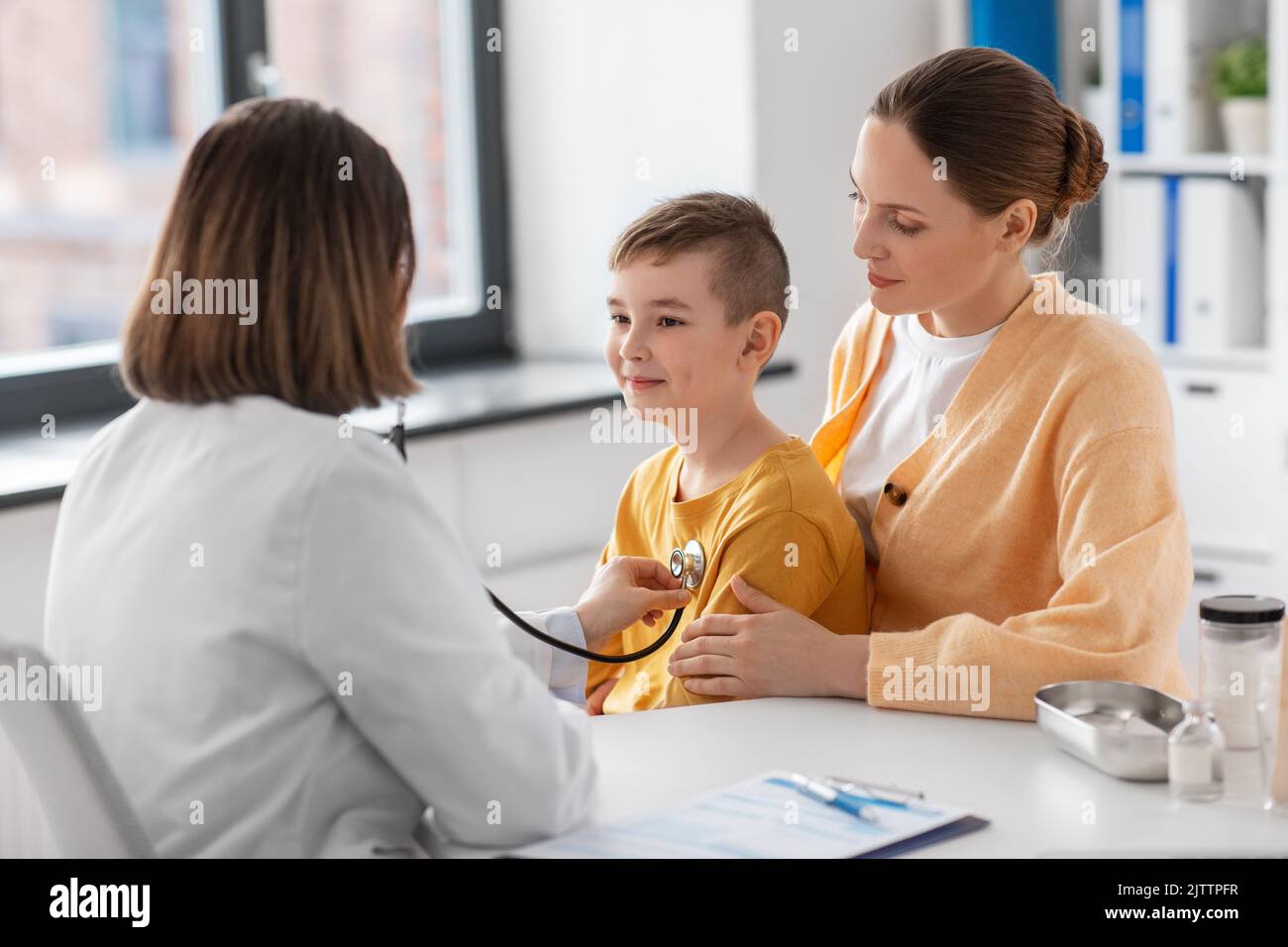 mother, son and doctor with stethoscope at clinic Stock Photo - Alamy
