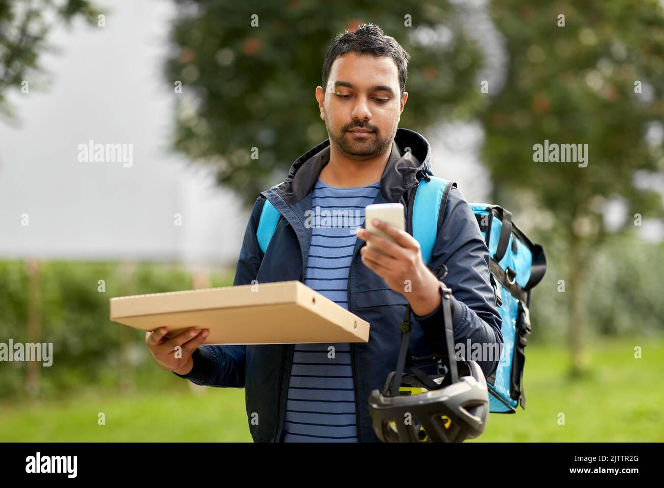food delivery man with takeaway pizza and phone Stock Photo Alamy