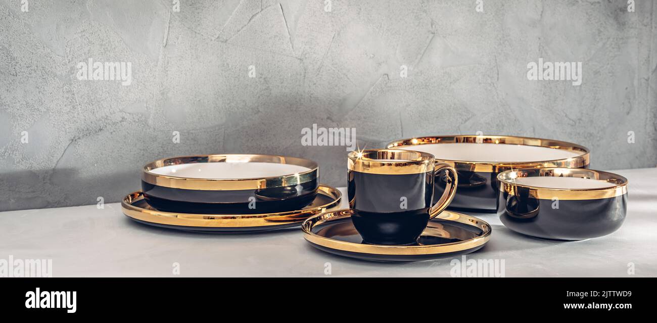 Black dishes with a gold rim Stock Photo Alamy