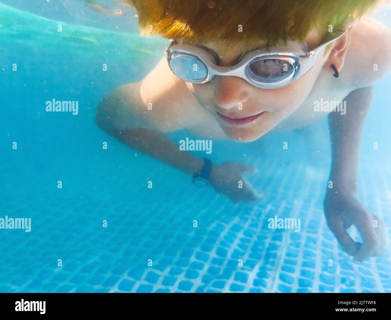 Boy swimming in the pool wearing swim goggles stock photo alamy