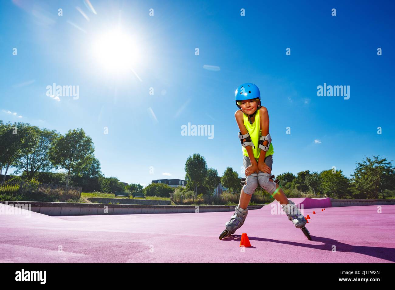 Boy pose standing on rollerblades in the skatepark Stock Photo Alamy