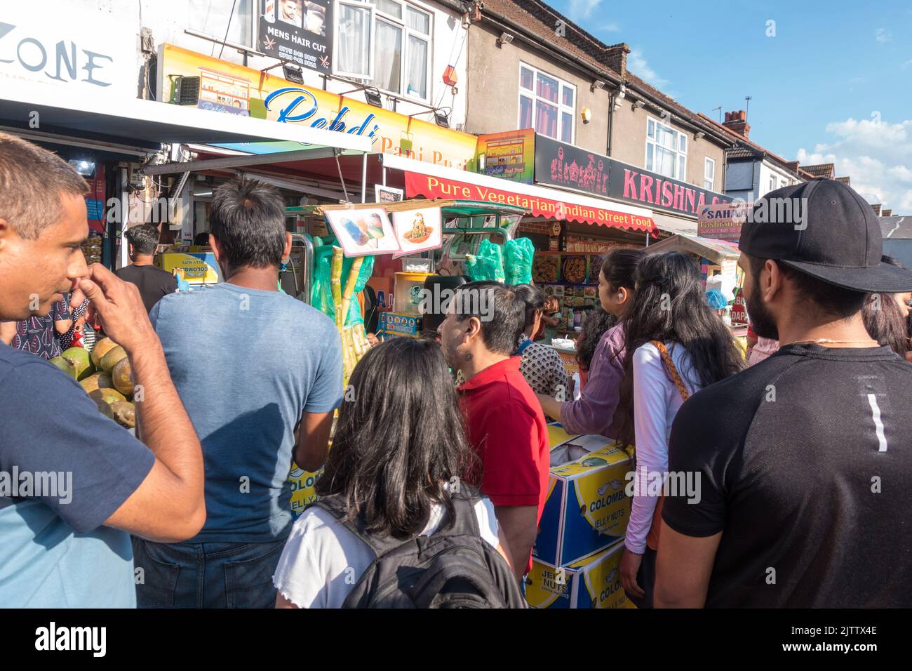 People queue in front of a Jelly coconut shop in Wembley Stock Photo