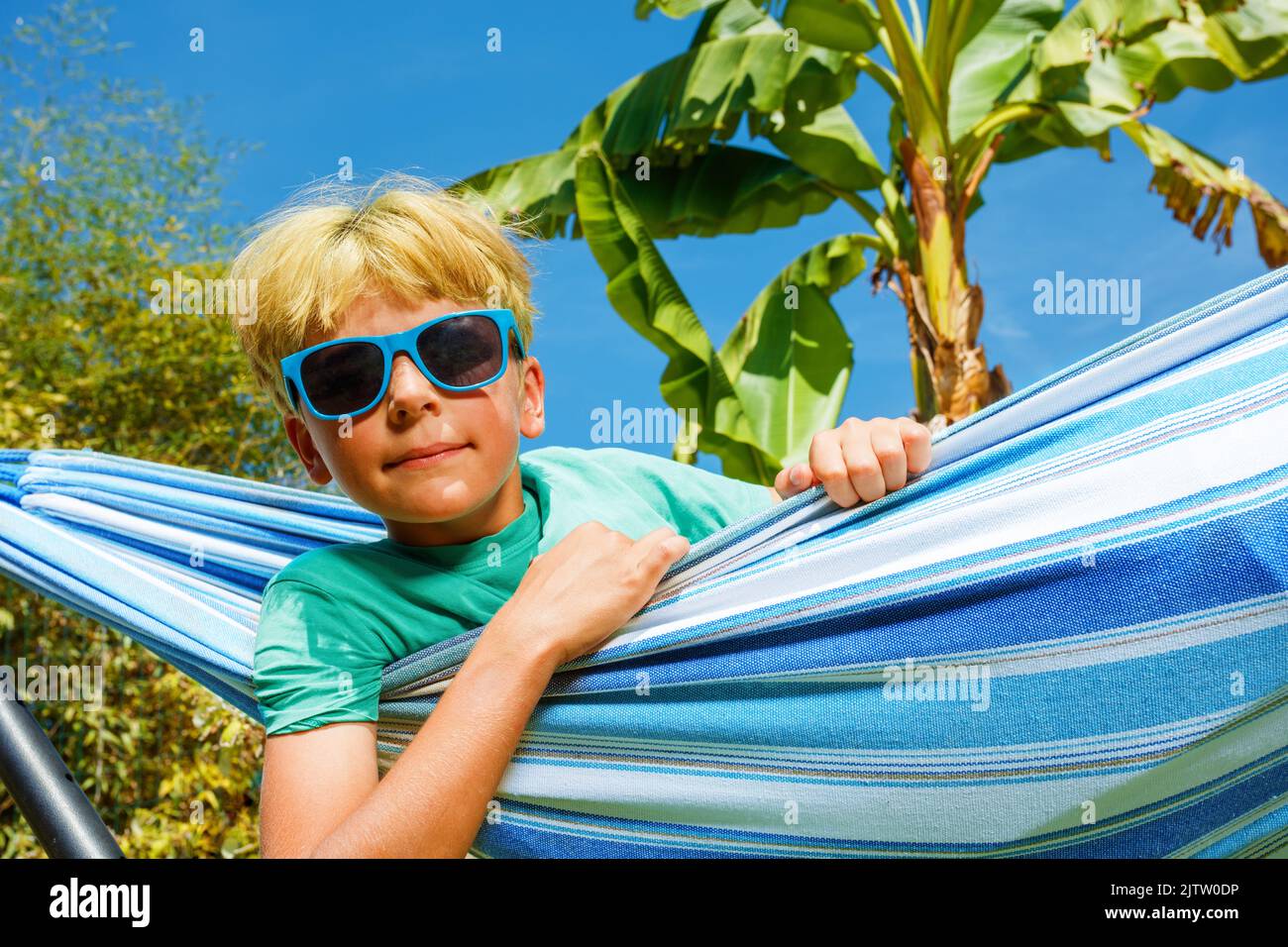 Close-up of a handsome preteen boy rest in hammock Stock Photo