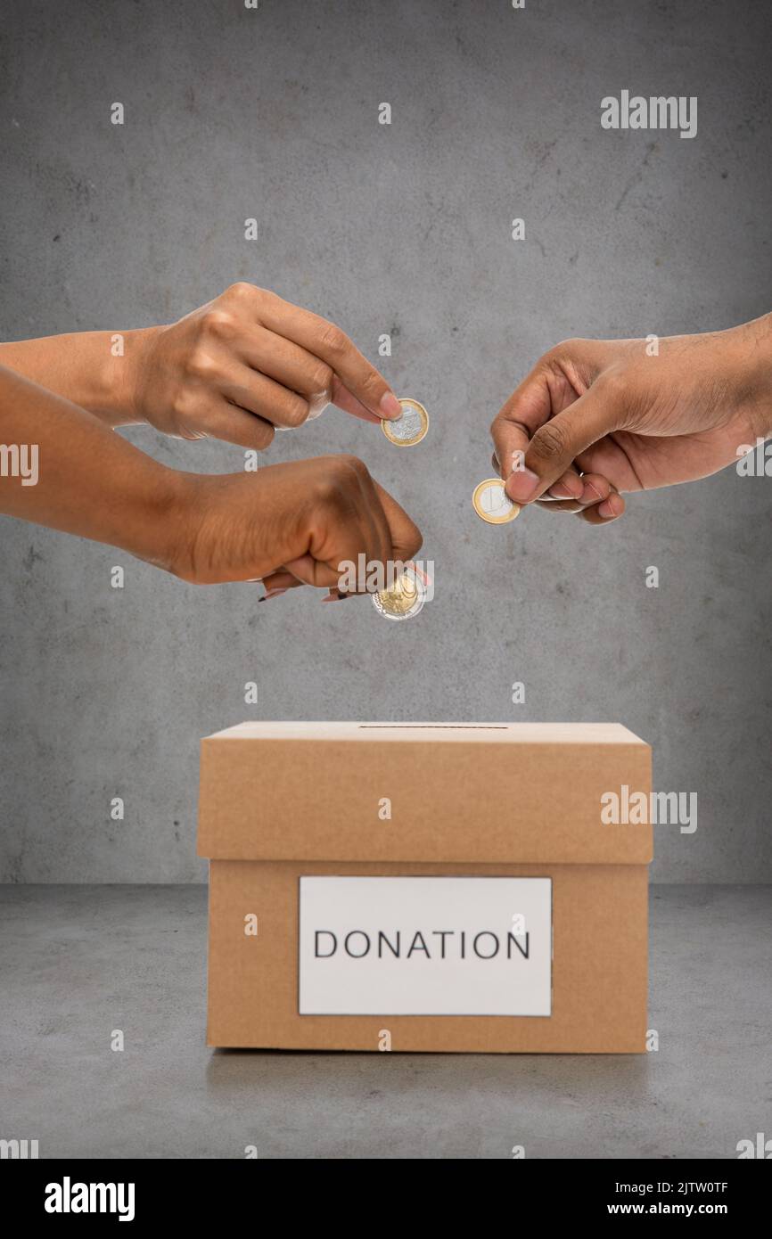 Black woman putting coins hi-res stock photography and images - Alamy