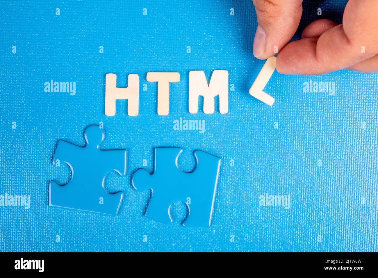 HTML. Text from white wooden letters on a blue background. Stock Photo