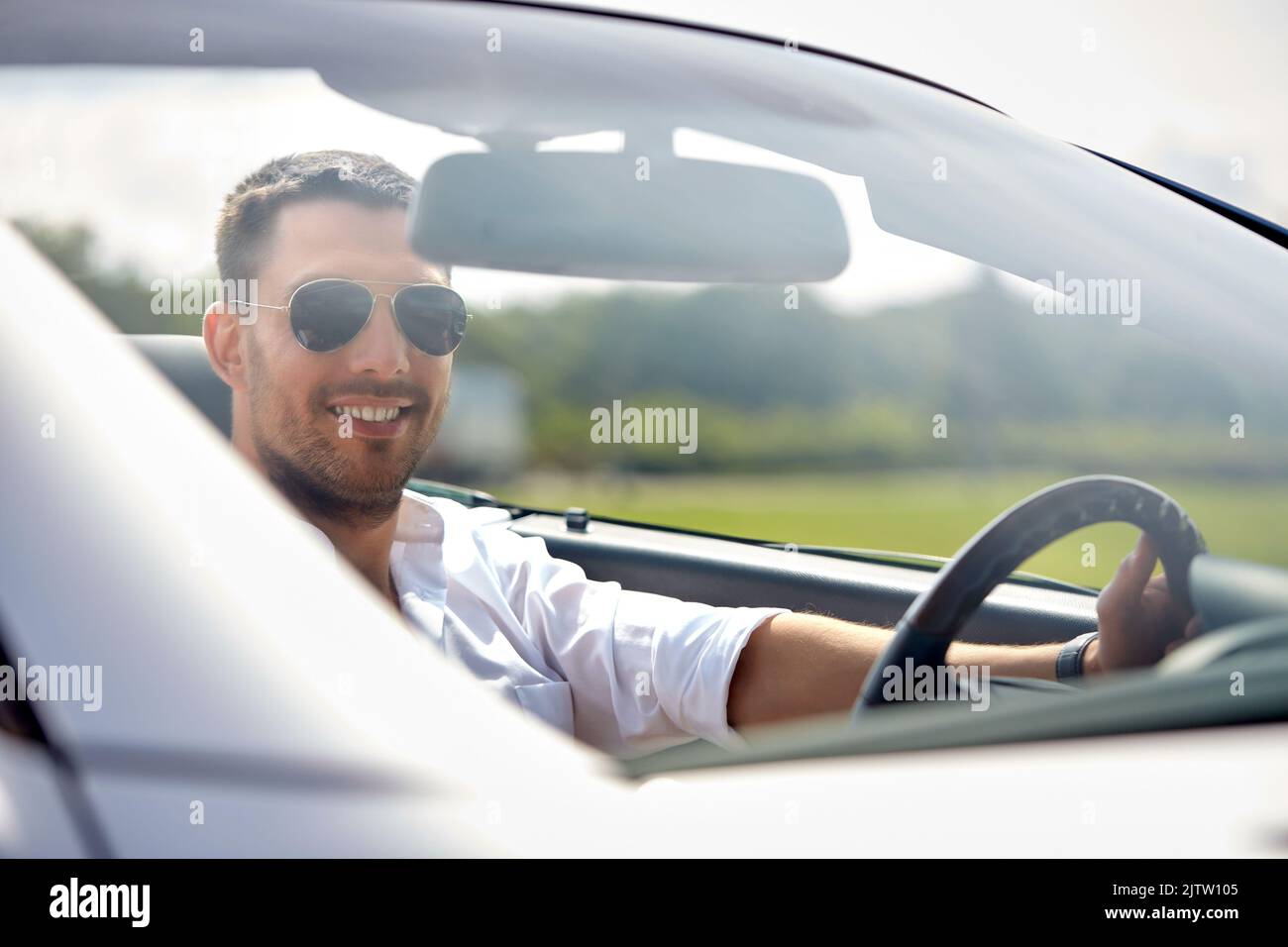 happy man in sunglasses driving convertible car Stock Photo