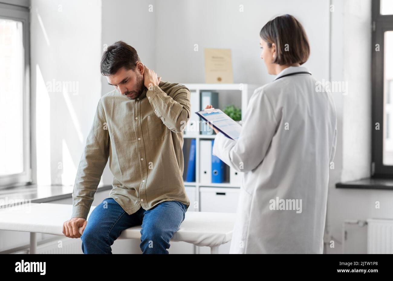 man patient showing sore arm to doctor at hospital Stock Photo Alamy