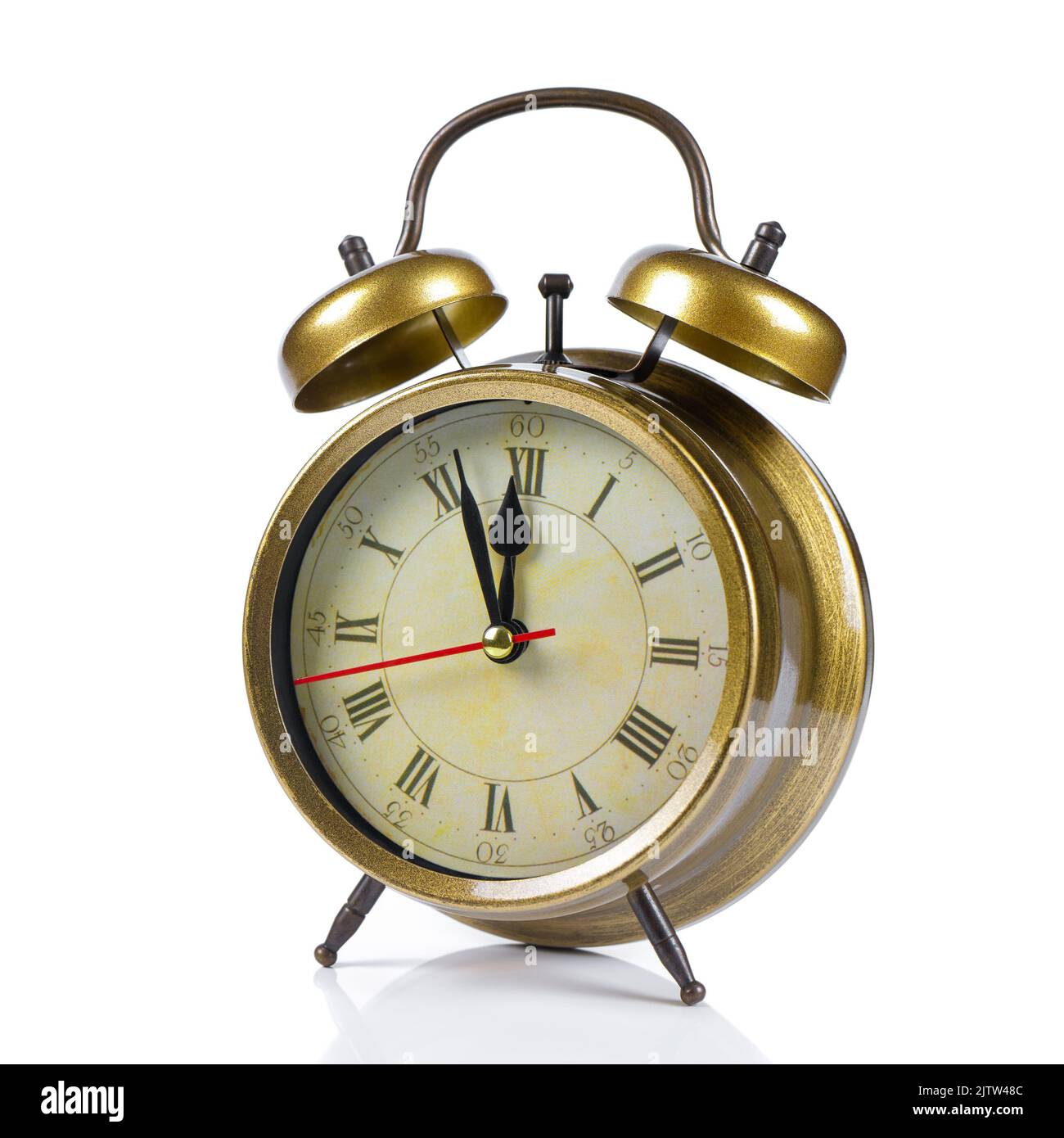 golden colored old style alarm clock isolated on white background