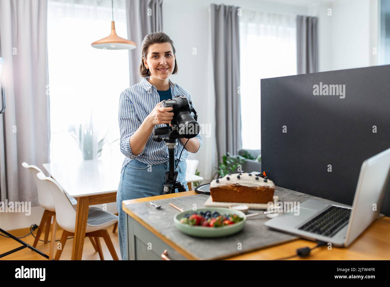 food photographer with camera working in kitchen Stock Photo - Alamy
