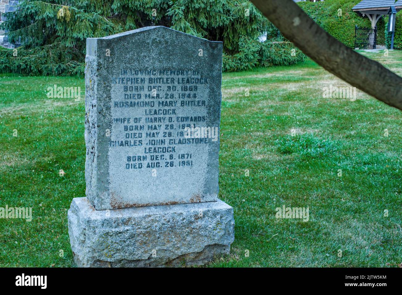Stephen Leacock's gravestone at St. George's Anglican Church at Sibbald Provincial Park on Lake Simcoe, Ontario, Canada. Stock Photo
