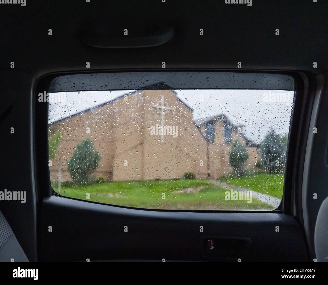 A church seen from a car window in the rain Stock Photo