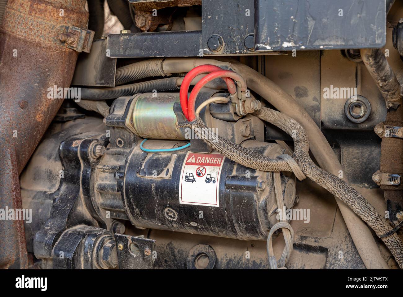Engine starter on farm tractor. Agriculture and farming equipment repair, maintenance and service concept Stock Photo