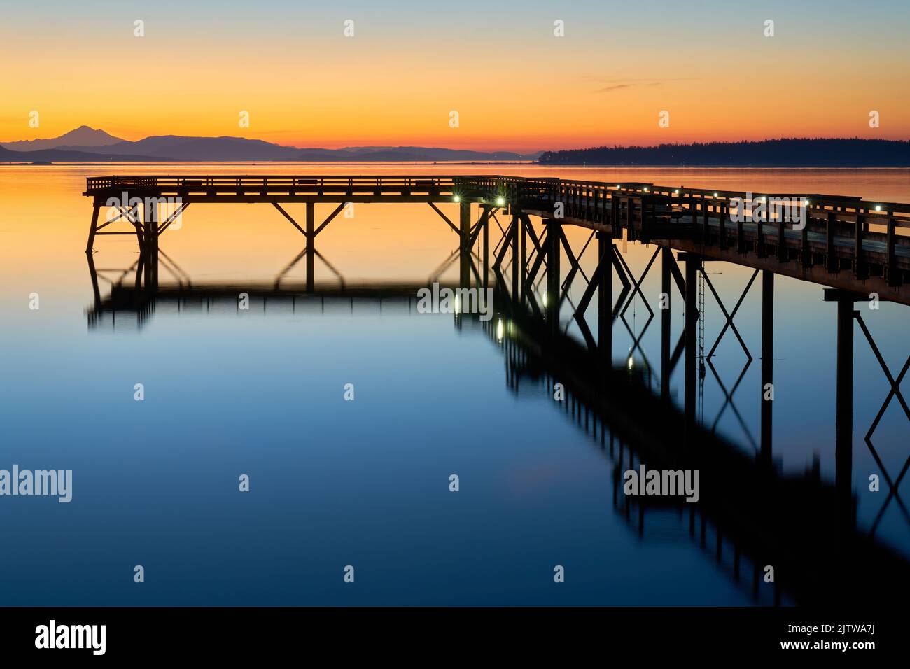 Sidney BC Fishing Pier Twilight Dawn. Summer dawn twilight behind the wooden fishing pier in Sidney British Columbia, Canada. Stock Photo