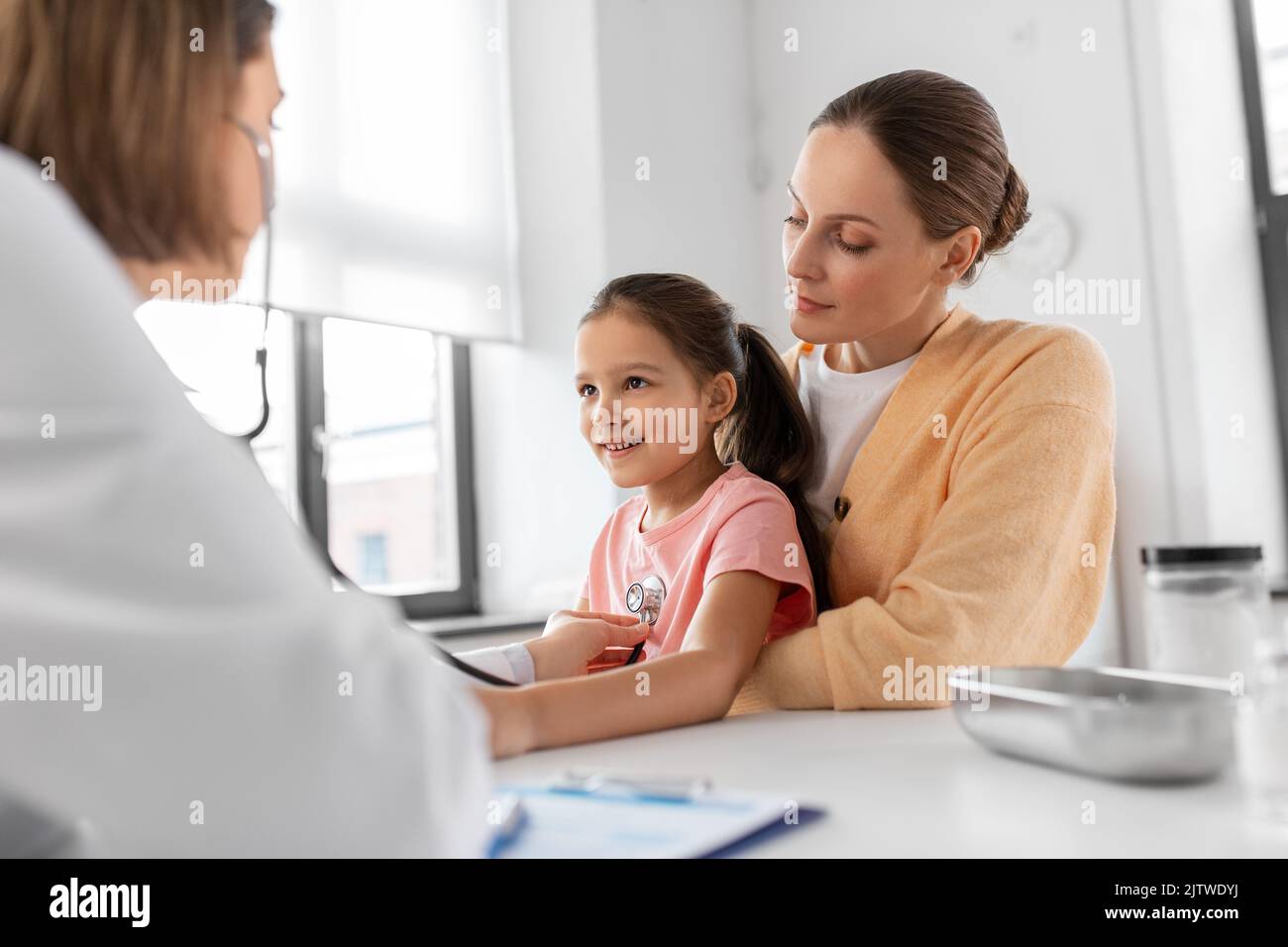 mother, girl and doctor with stethoscope at clinic Stock Photo - Alamy