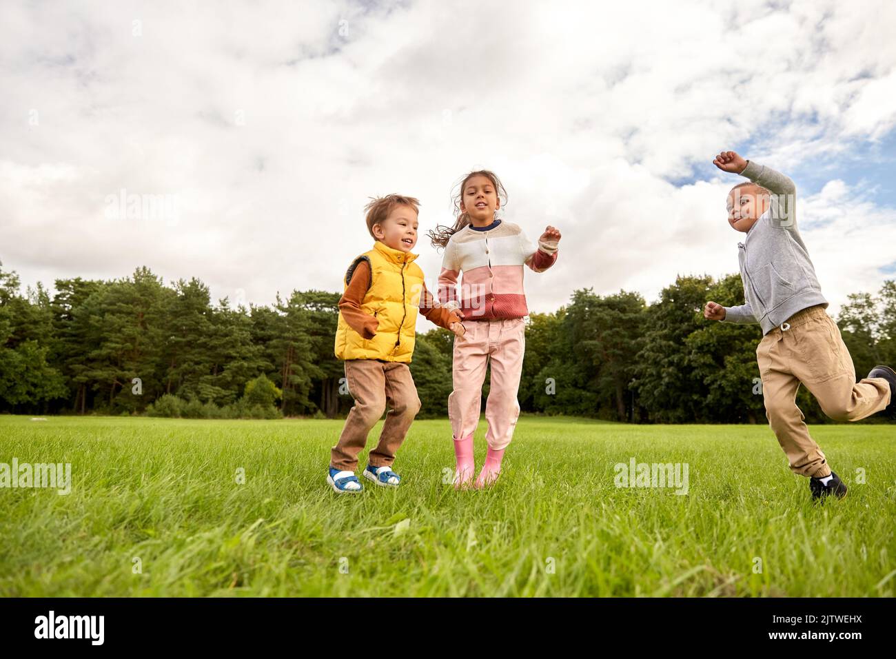 happy children playing and jumping at park Stock Photo - Alamy