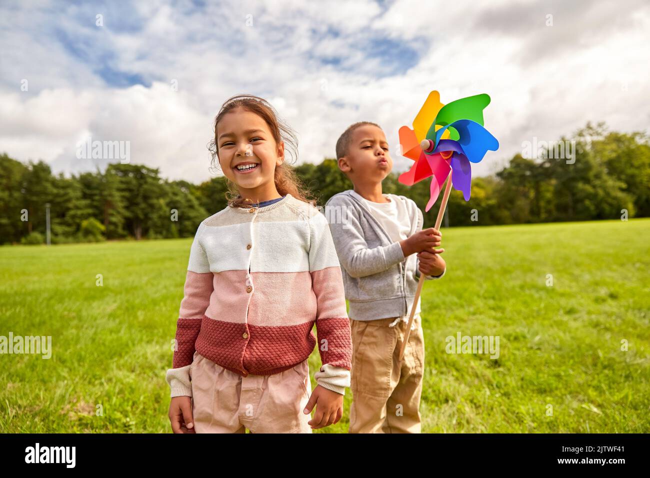happy children playing with pinwheel at park Stock Photo - Alamy