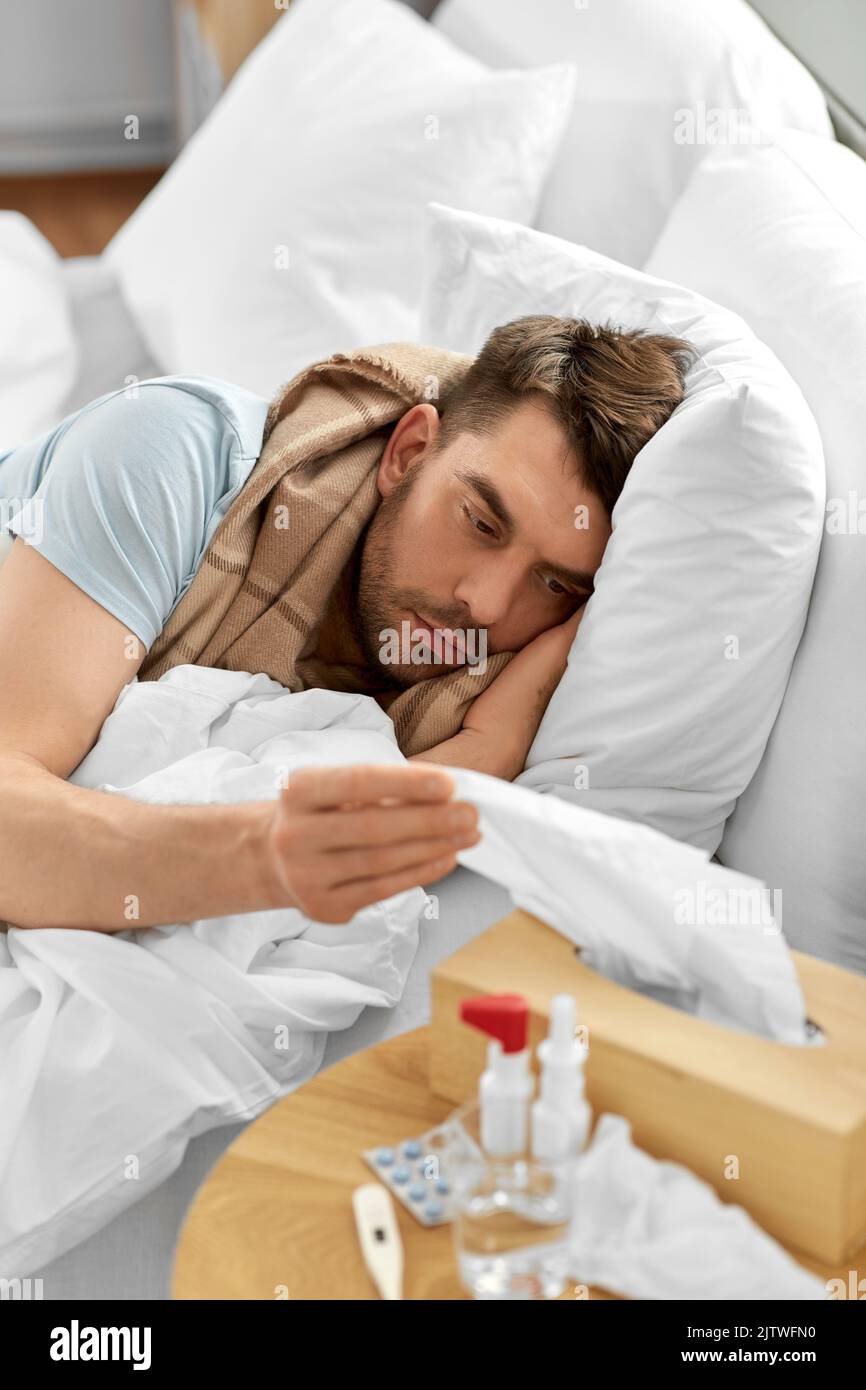 Sick man lying in bed hi-res stock photography and images - Alamy