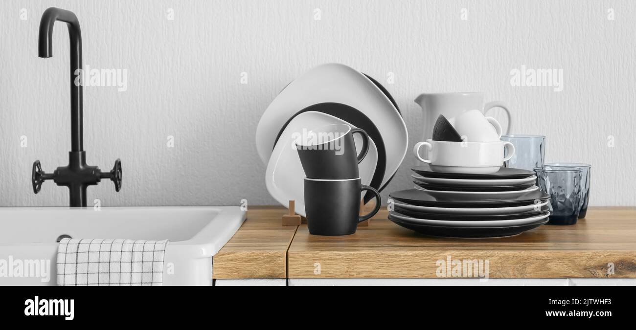 Interior of stylish kitchen with dinnerware and sink on counter Stock ...