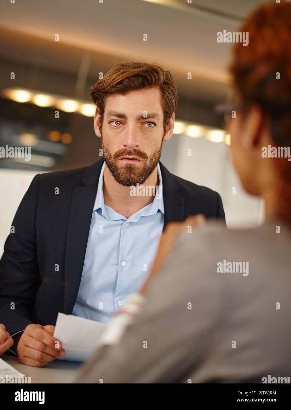 Weve got some serious matters to discuss. a businessman having a face to face meeting with a colleague at work. Stock Photo