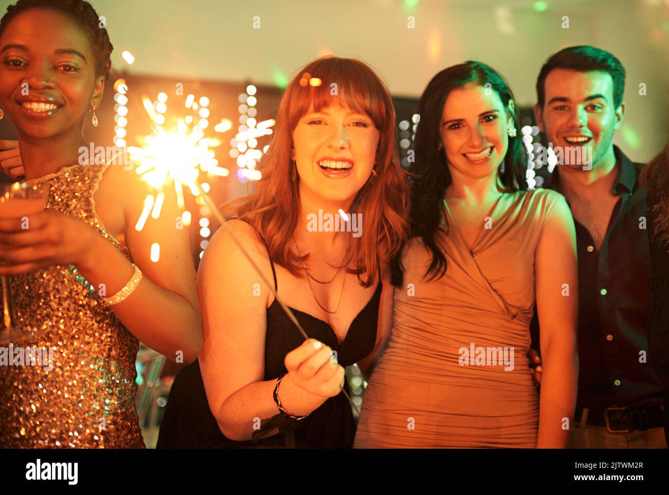 Lets get this party started. a group of girlfriends having fun with sparklers on a night out