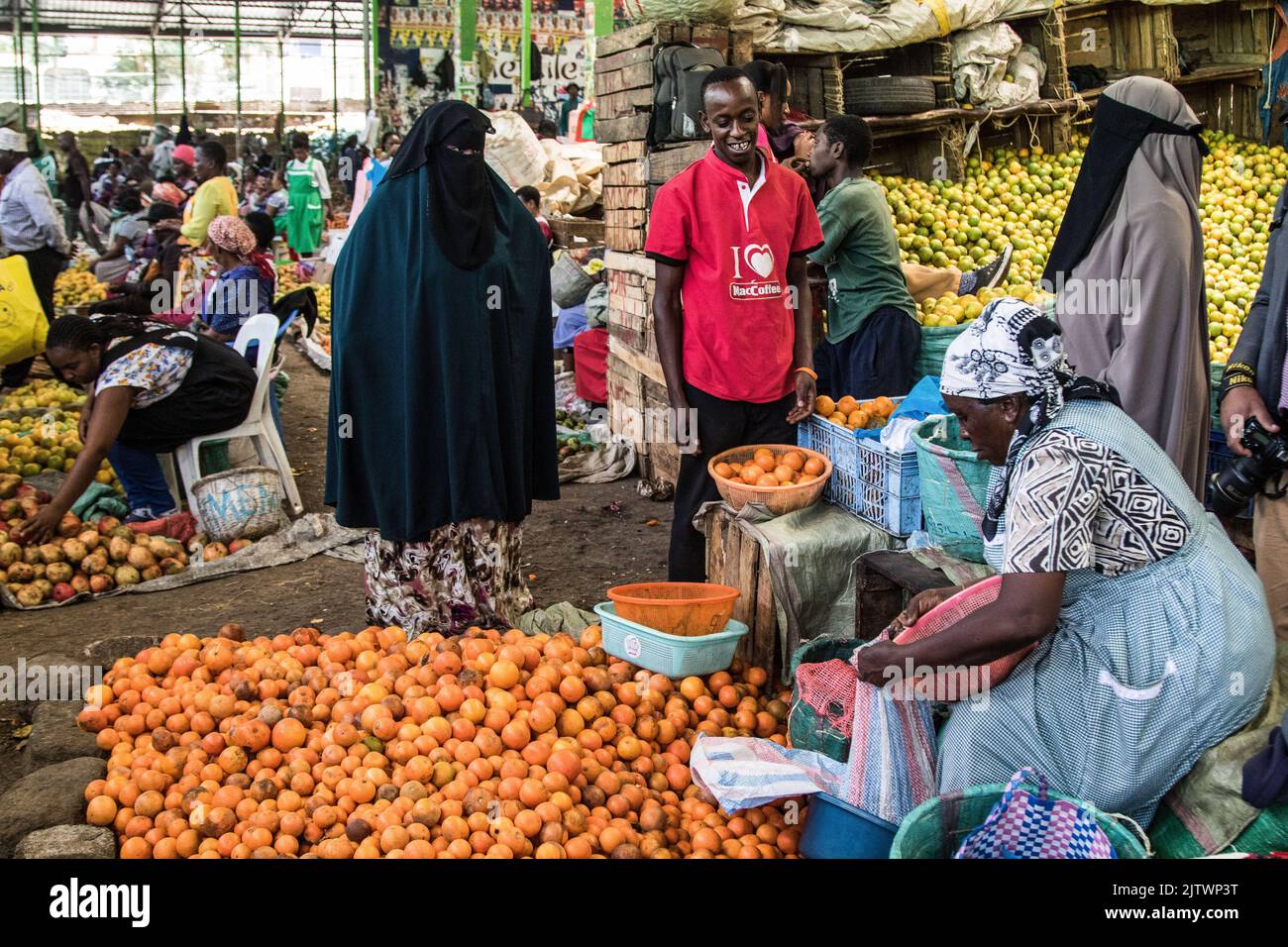 Nakuru, Kenya. 01st Sep, 2022. People buy oranges from a trader at a