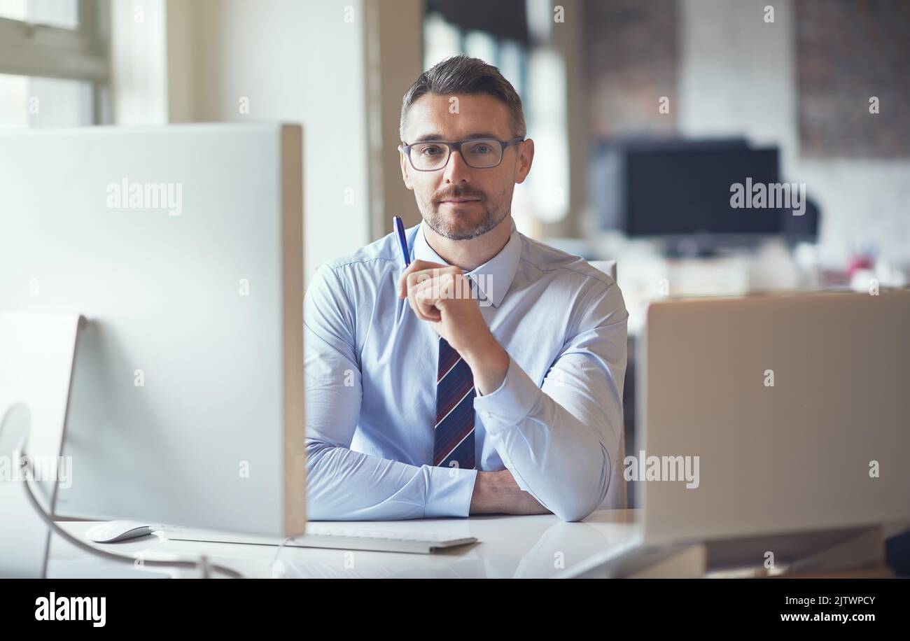 Computers make my job so much easier. a businessman sitting by his ...