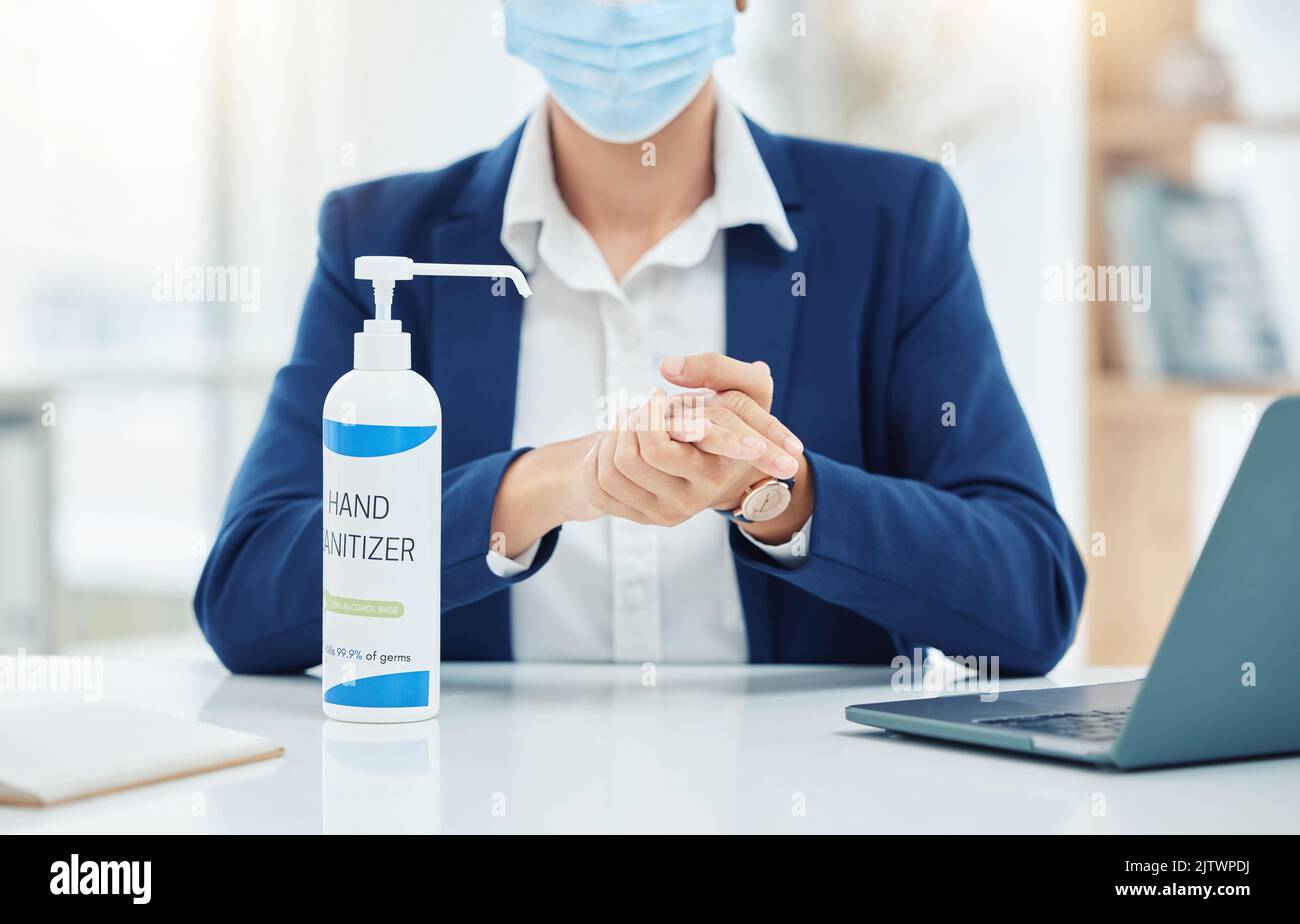 Cleaning, compliance and covid rules at work by business woman sanitize