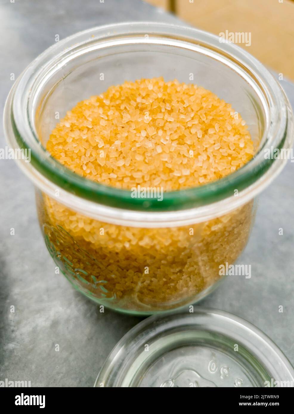 Close up of brown sugar,set outdoors on a restaurant table,to be used for adding to a drink of hot coffee. Stock Photo