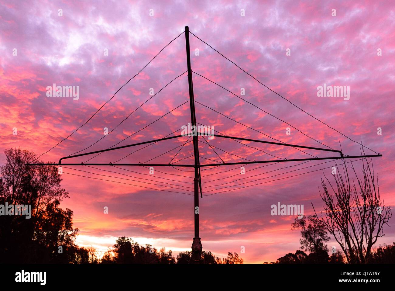 A Hills Hoist clothes line at sunset with a dramatic sky Stock Photo