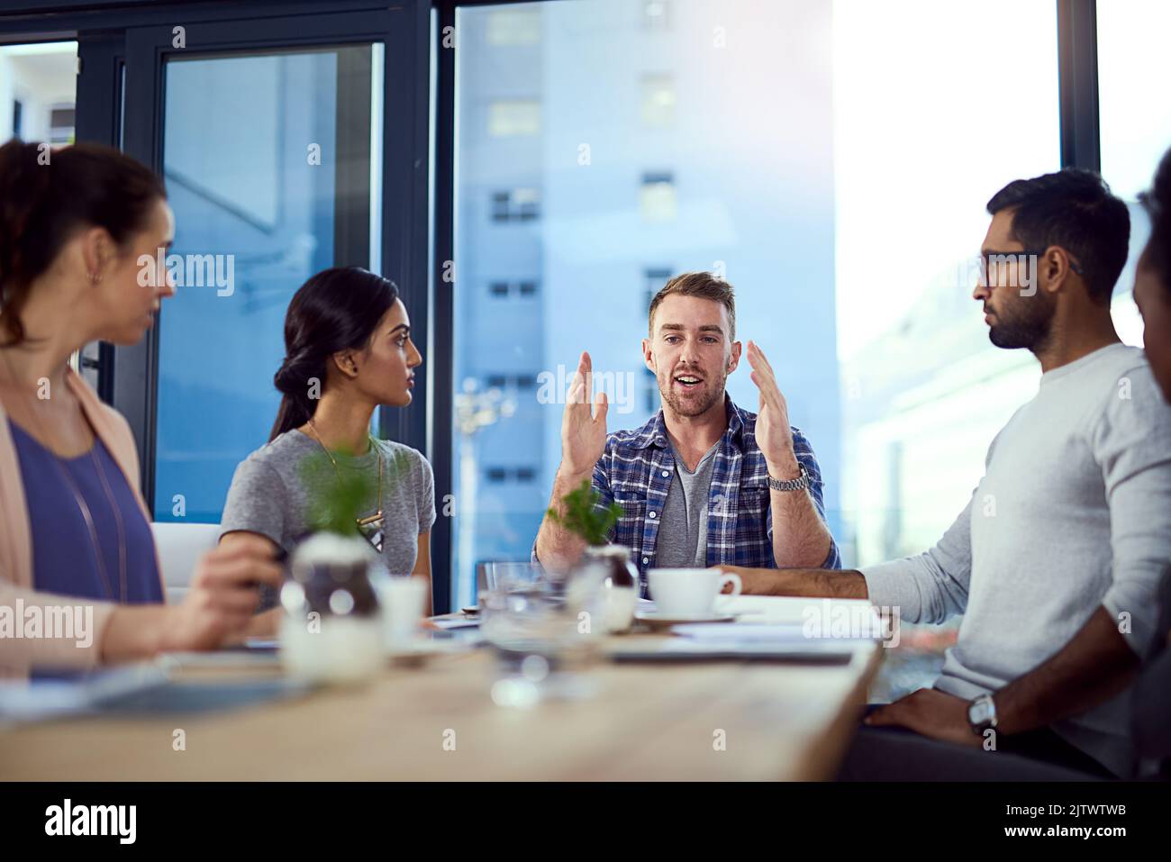 We dont imitate, we innovate. a young businessman explaining an idea to his team during a meeting. Stock Photo