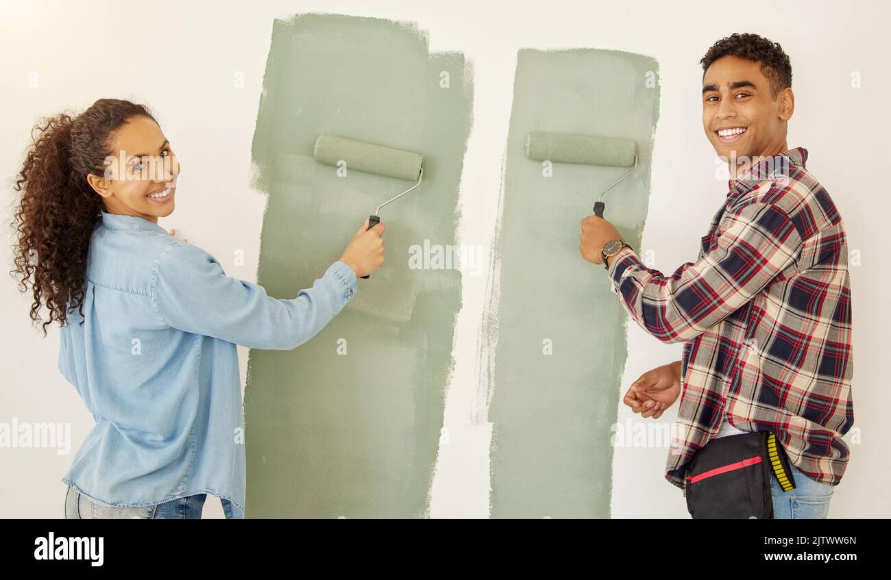 Portrait of happy couple painting room or interior house renovation and home or property design project with smile, white wall background. New home or Stock Photo