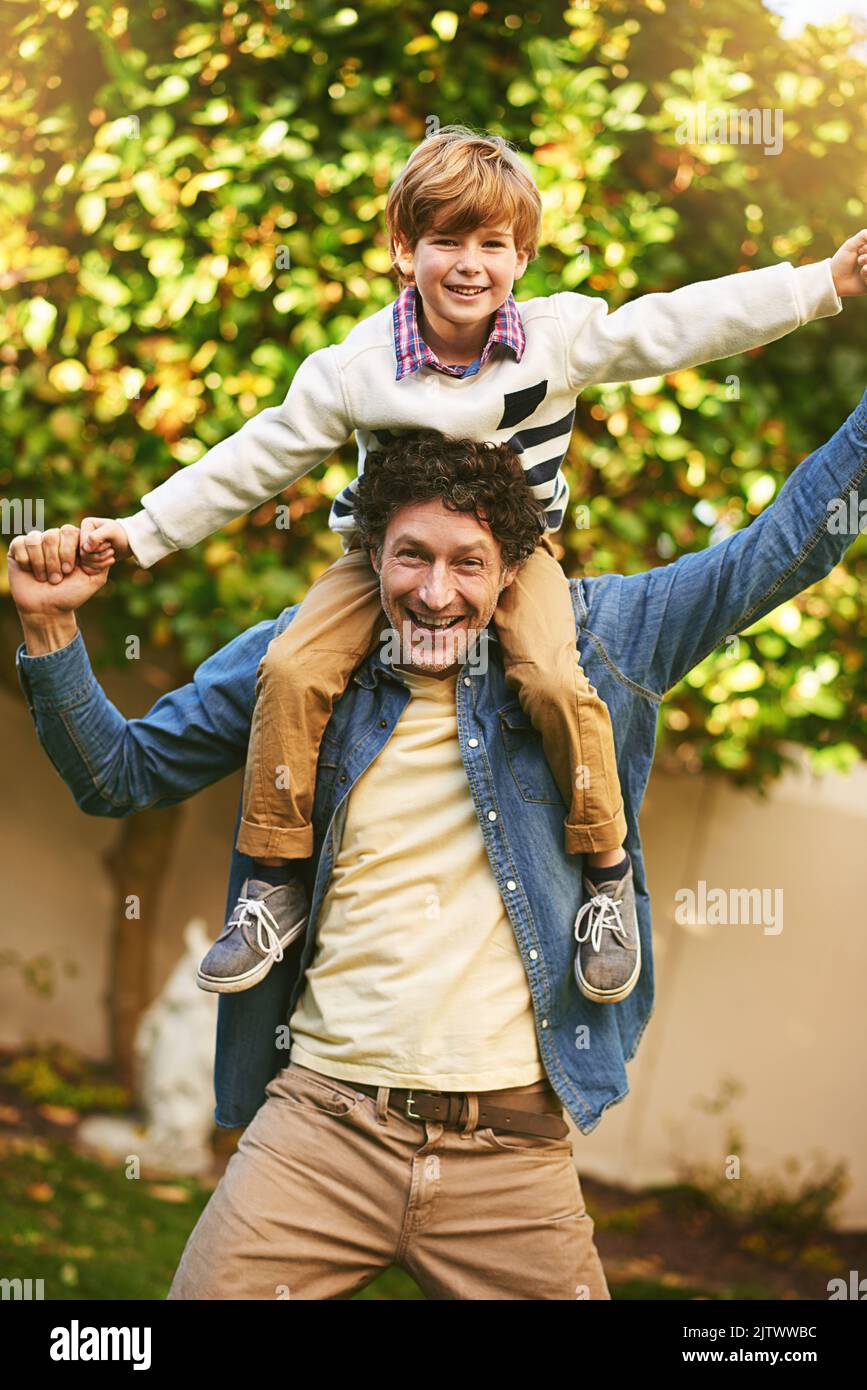 We became friends not just father and son. Portrait of a father and his son playing outdoors. Stock Photo