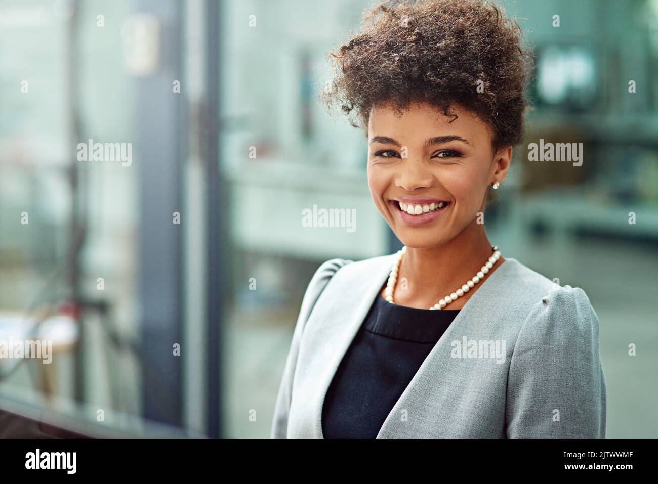 Moving and shaking her way up the corporate ladder. Cropped portrait of a smiling young businesswoman in her office. Stock Photo