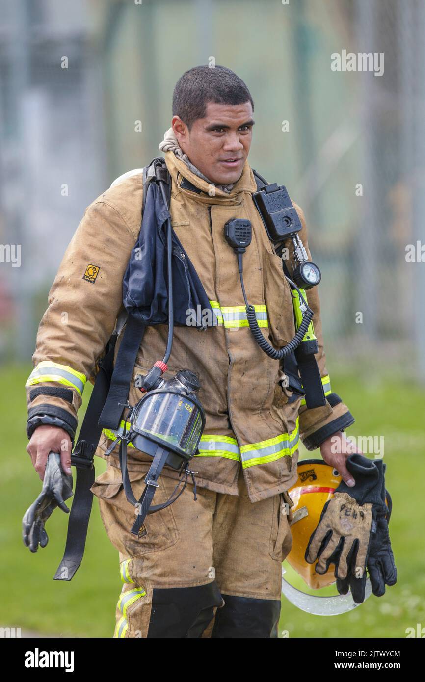 A fireman wearing breathing apparatus returning from a fire scene Stock Photo