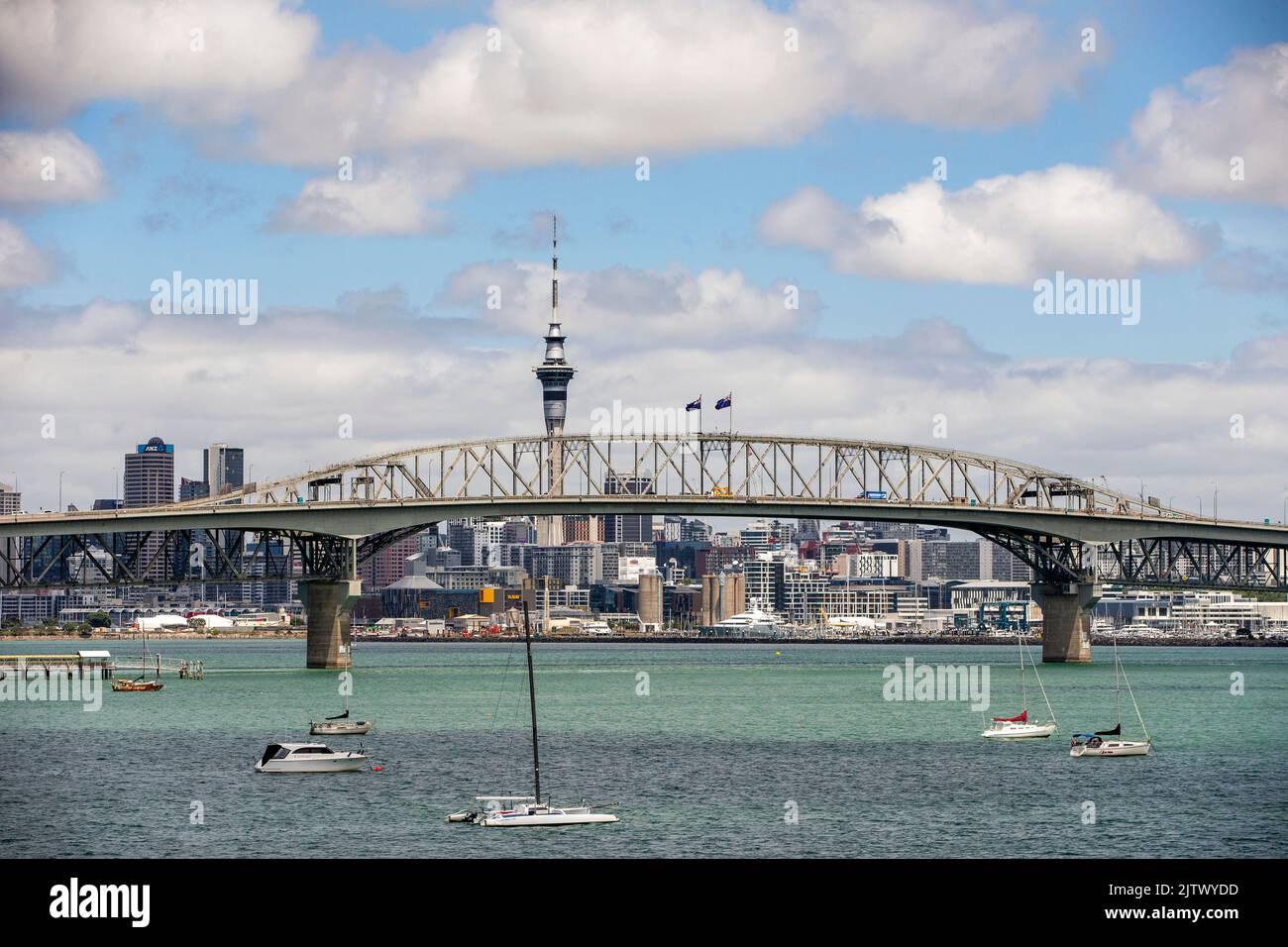 Auckland Harbour Bridge with Sky Tower and city in background, Auckland, New Zealand Stock Photo