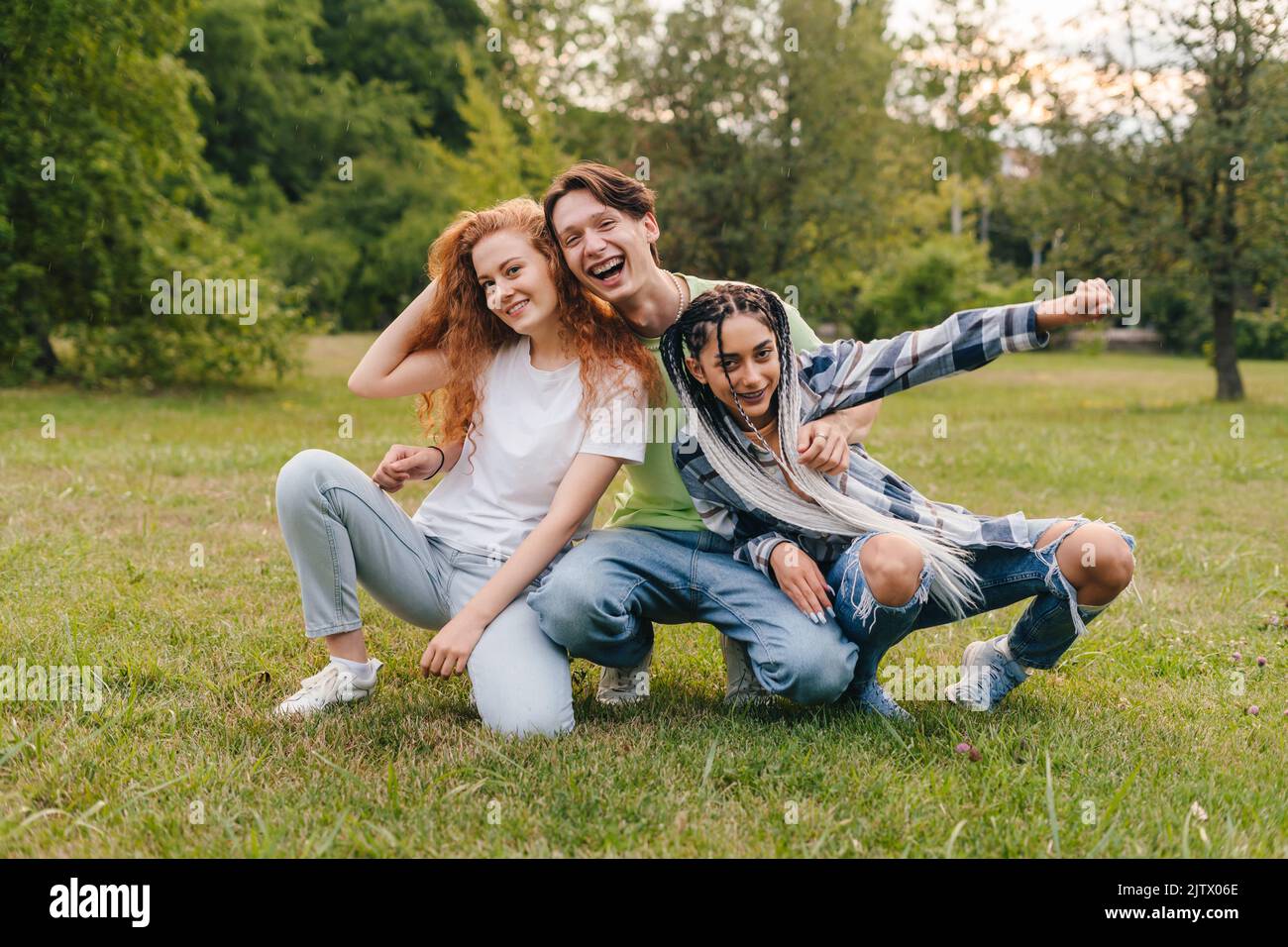 Caucasian bloggers enjoying funny moment while posing in the city park