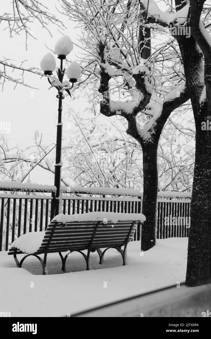 Image of a bench and snow covered trees. Guardiagrele abruzzo Italy in winter Stock Photo